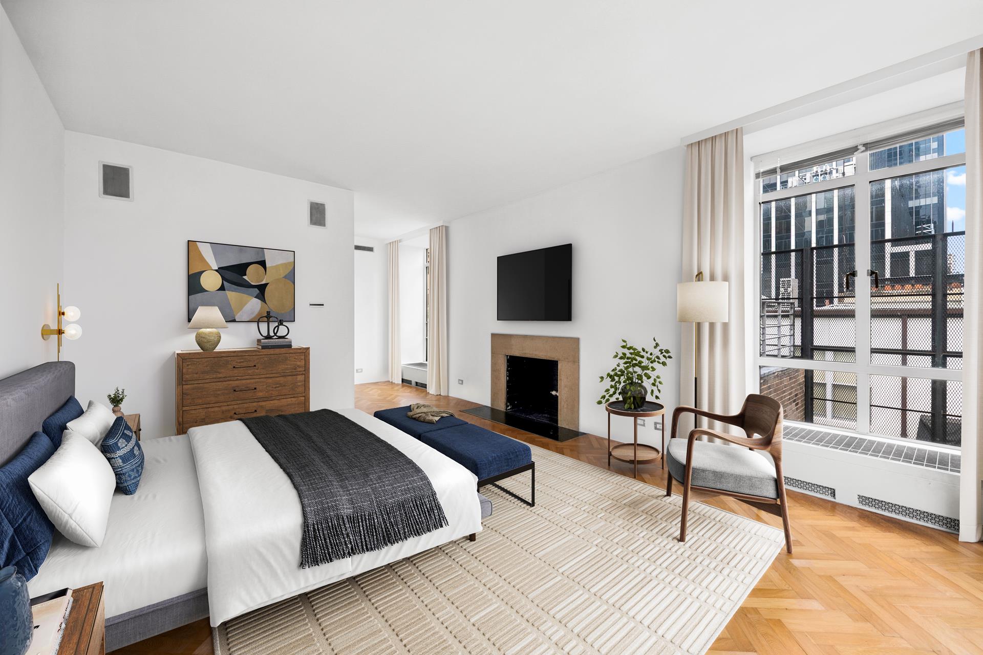24 West 55th Street, Unit 11D Manhattan, NY 10019 - Photo 9 of 18 a spacious bedroom with a bed and a fireplace