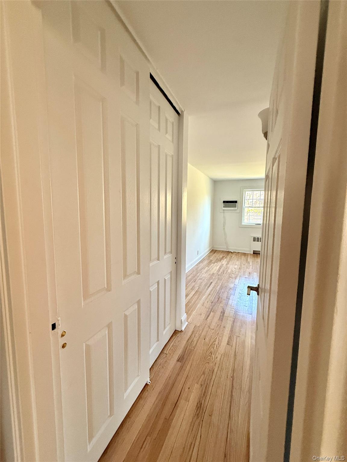 224-06 Springfield Boulevard, Unit 7815B Queens, NY 11364 - Photo 14 of 18 a view of a hallway with wooden floor and staircase