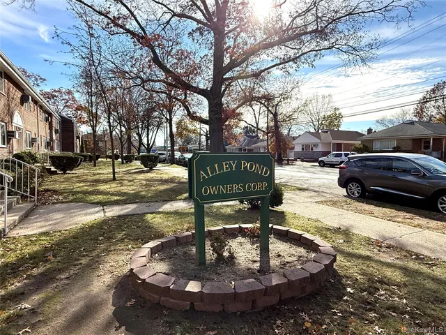 a sign that is sitting on a sidewalk