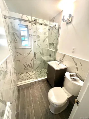 a white toilet sitting next to a bathroom sink