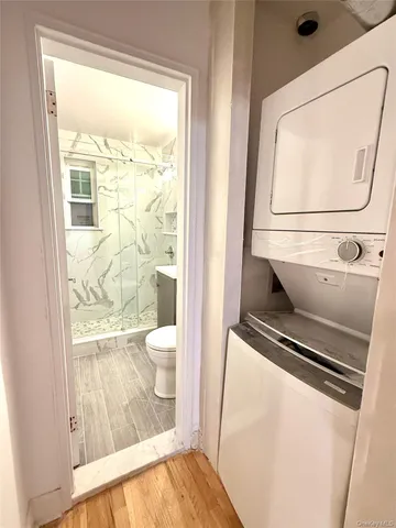 a bathroom with a toilet a sink and a window