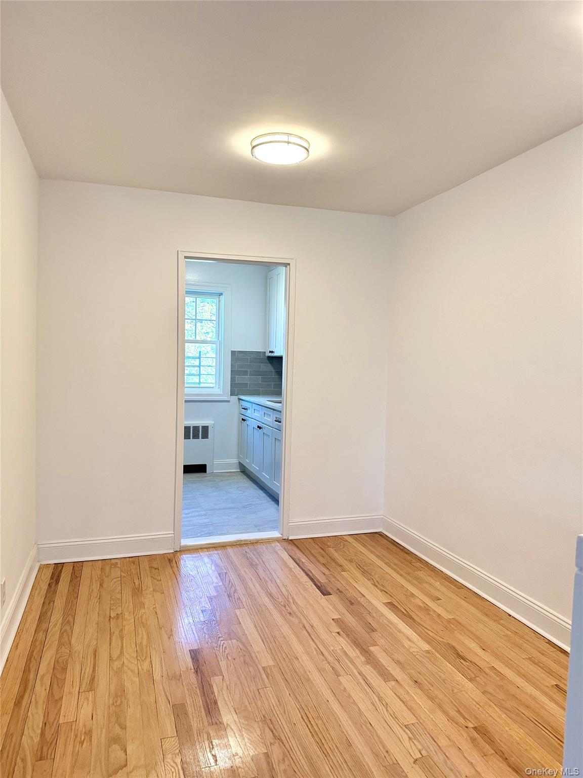 224-06 Springfield Boulevard, Unit 7815B Queens, NY 11364 - Photo 5 of 18 a view of a room with wooden floor and bathroom