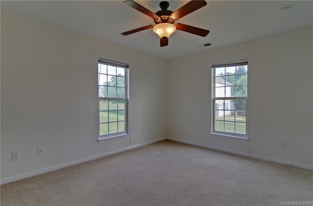213 Grayland Road Mooresville, NC 28115 - Photo 7 of 15 an empty room with windows and fan