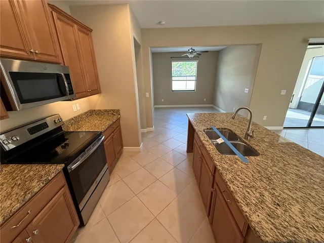 a kitchen with a sink stove and microwave