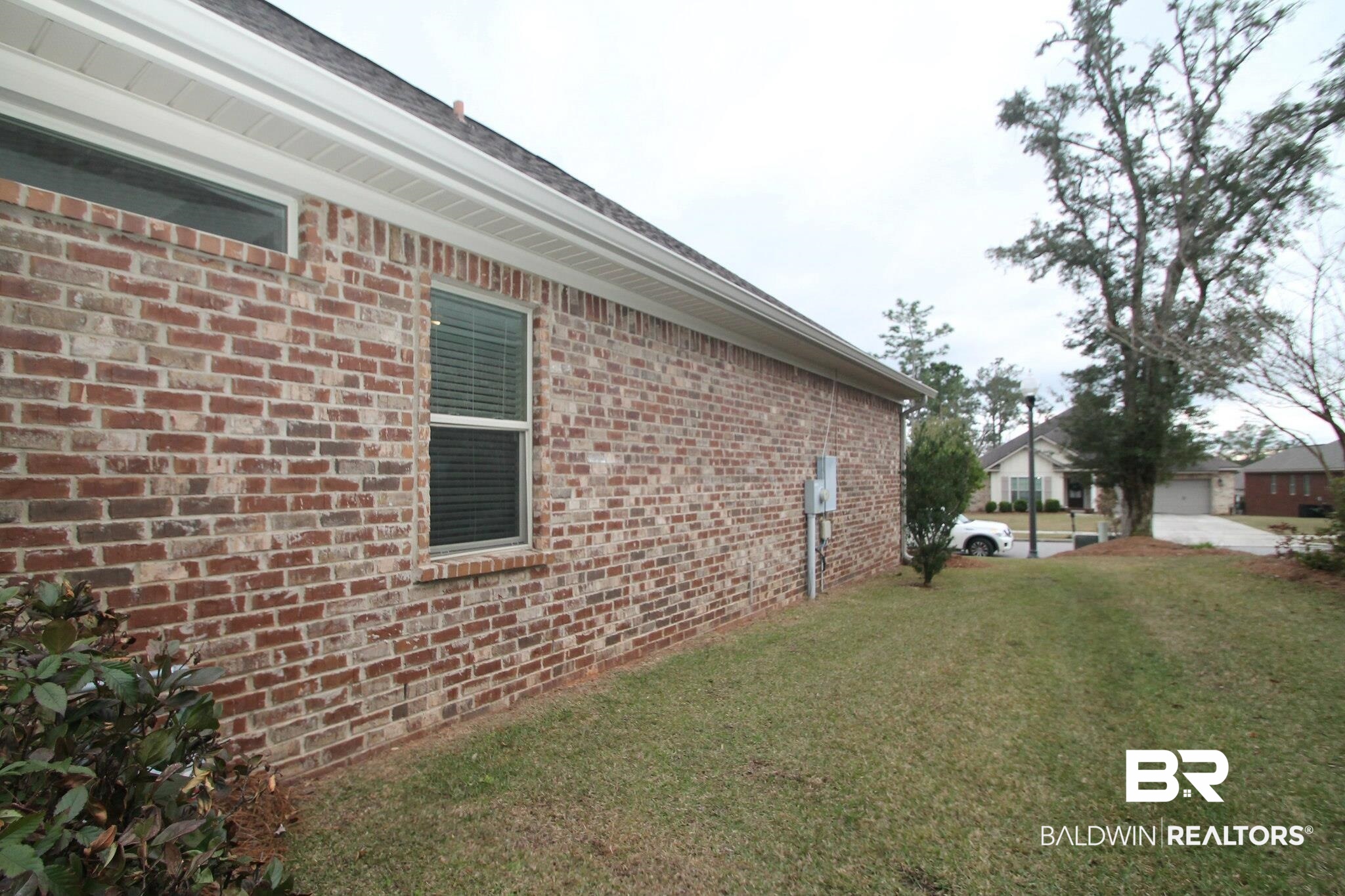 30232 Persimmon Drive Daphne, AL 36527 - Photo 26 of 27 View of property exterior featuring a yard and brick siding
