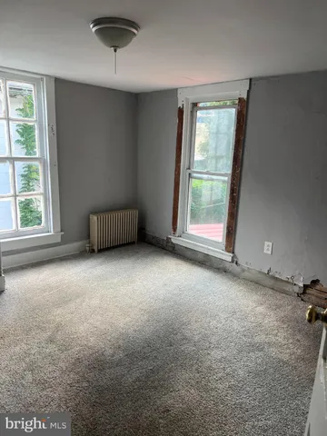 an empty room with a empty space and windows