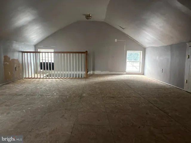 an empty room with a empty space and windows