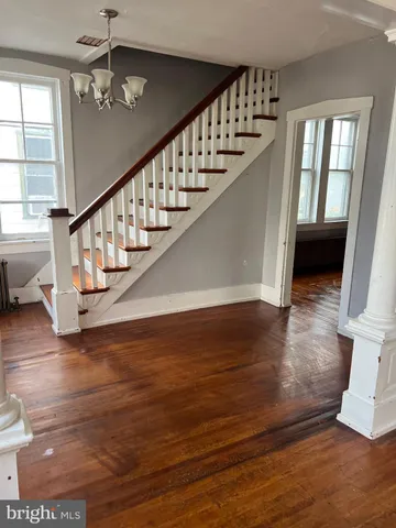 a view of entryway and hall with wooden floor