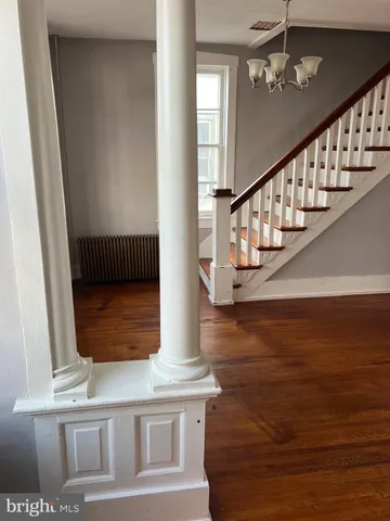 a view of entryway and hall with wooden floor