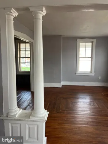 a view of wooden floor and cabinet in a room