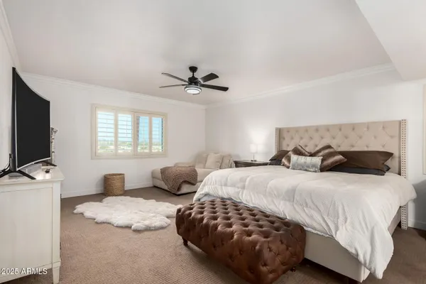 a bedroom with a bed and flat screen tv