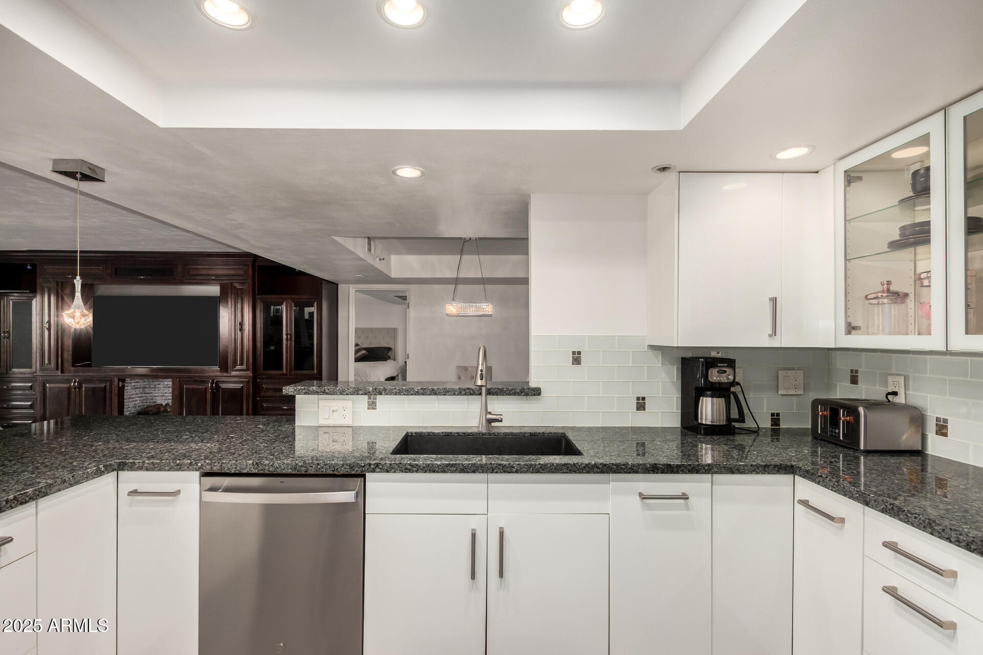 7970 East Camelback Road, Unit 507 Scottsdale, AZ 85251 - Photo 14 of 33 a kitchen with granite countertop a sink a stove cabinets and counter space