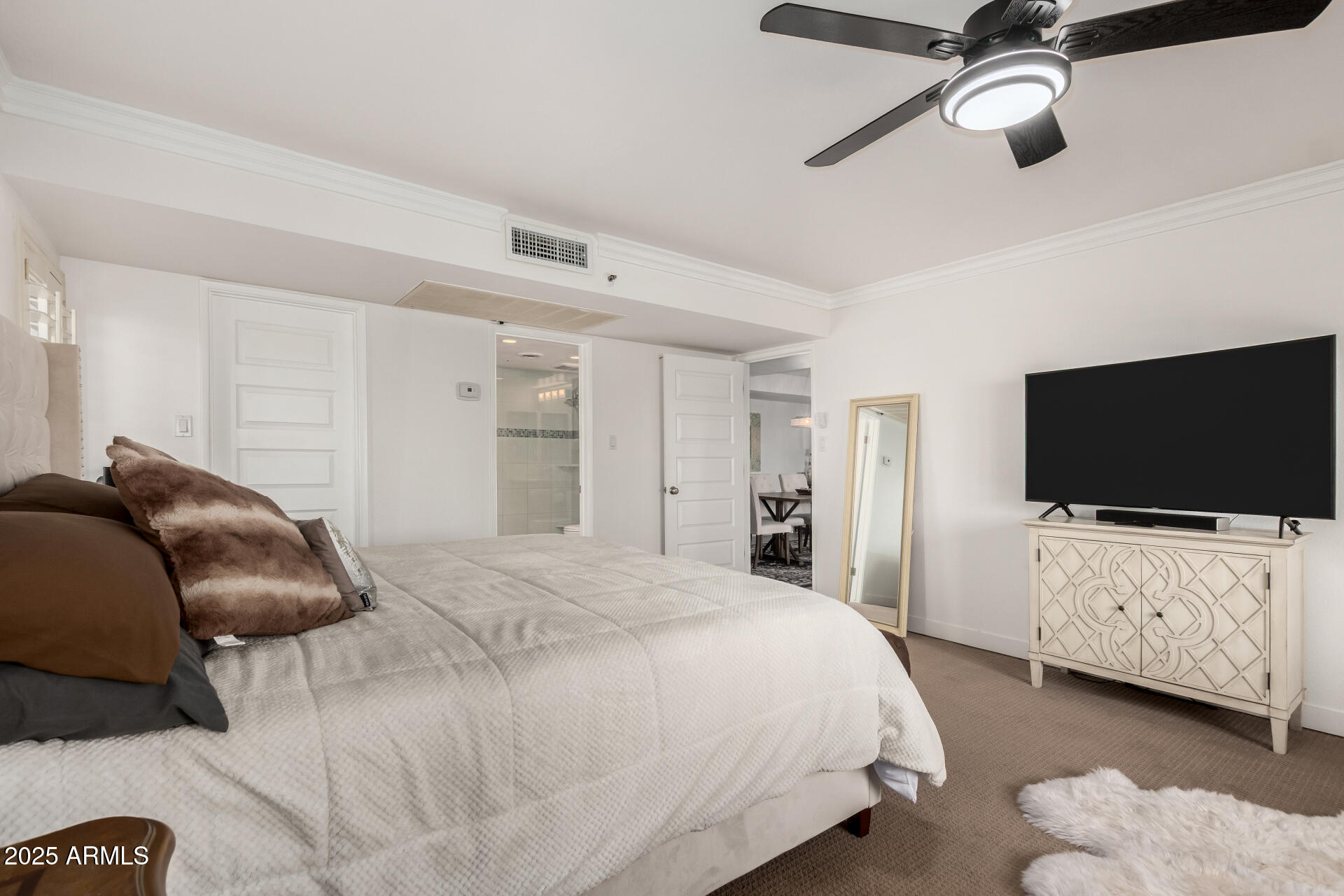 7970 East Camelback Road, Unit 507 Scottsdale, AZ 85251 - Photo 15 of 33 a bedroom with a bed and a flat screen tv