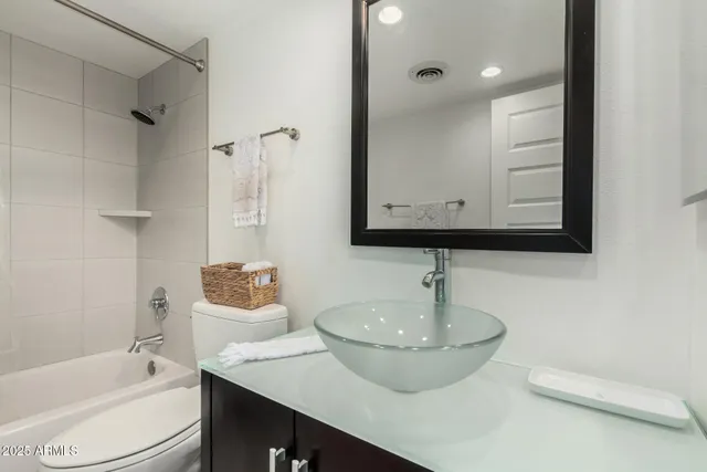 a bathroom with a sink a toilet and bathtub