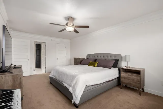 a bedroom with a bed and a chandelier