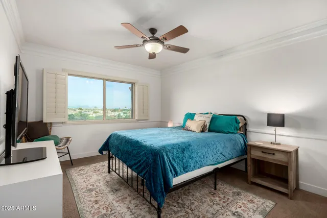 a bedroom with a bed and a flat screen tv