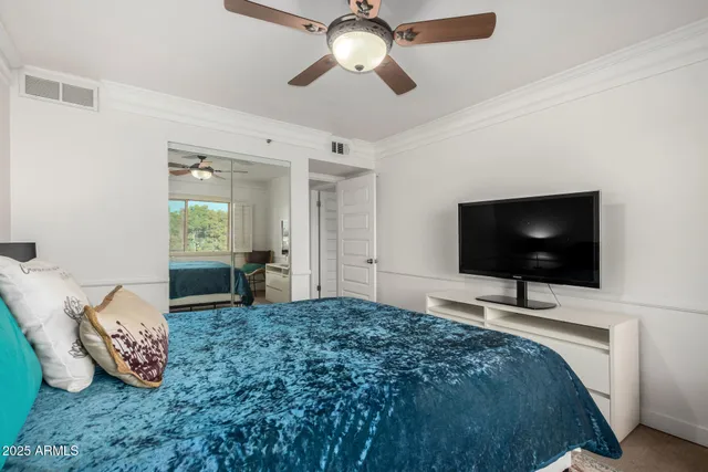 a bedroom with a bed and a flat screen tv