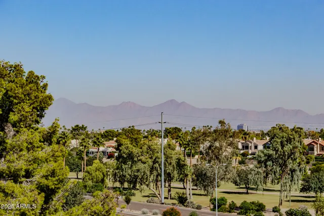 a view of a town with mountains in the background