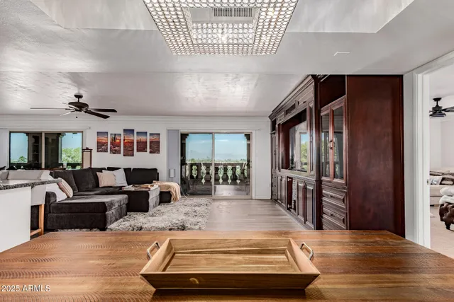 a view of a livingroom with furniture wooden floor and windows