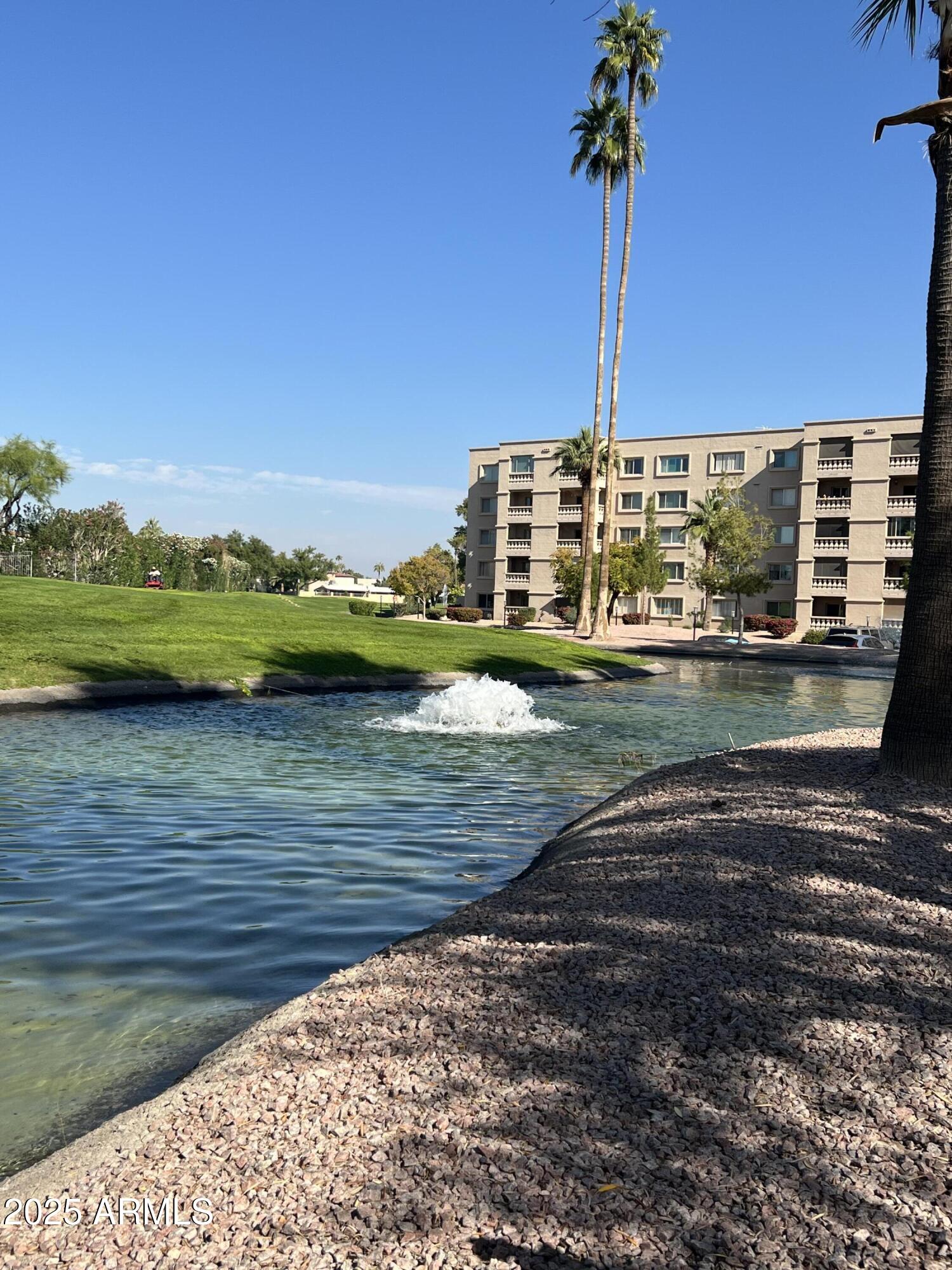 7970 East Camelback Road, Unit 507 Scottsdale, AZ 85251 - Photo 31 of 33 a view of a lake with a big yard