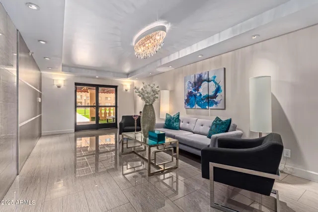 a living room with furniture a dining table and a large window