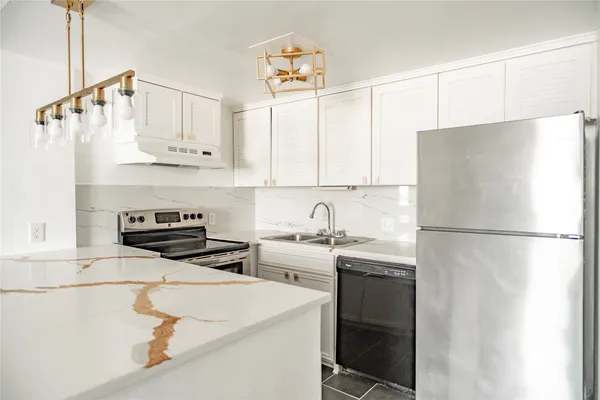 a kitchen with stainless steel appliances a refrigerator sink and cabinets