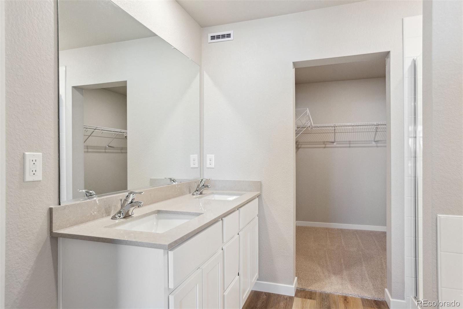 48165 Shetland Drive Bennett, CO 80102 - Photo 13 of 21 a bathroom with a sink and a mirror