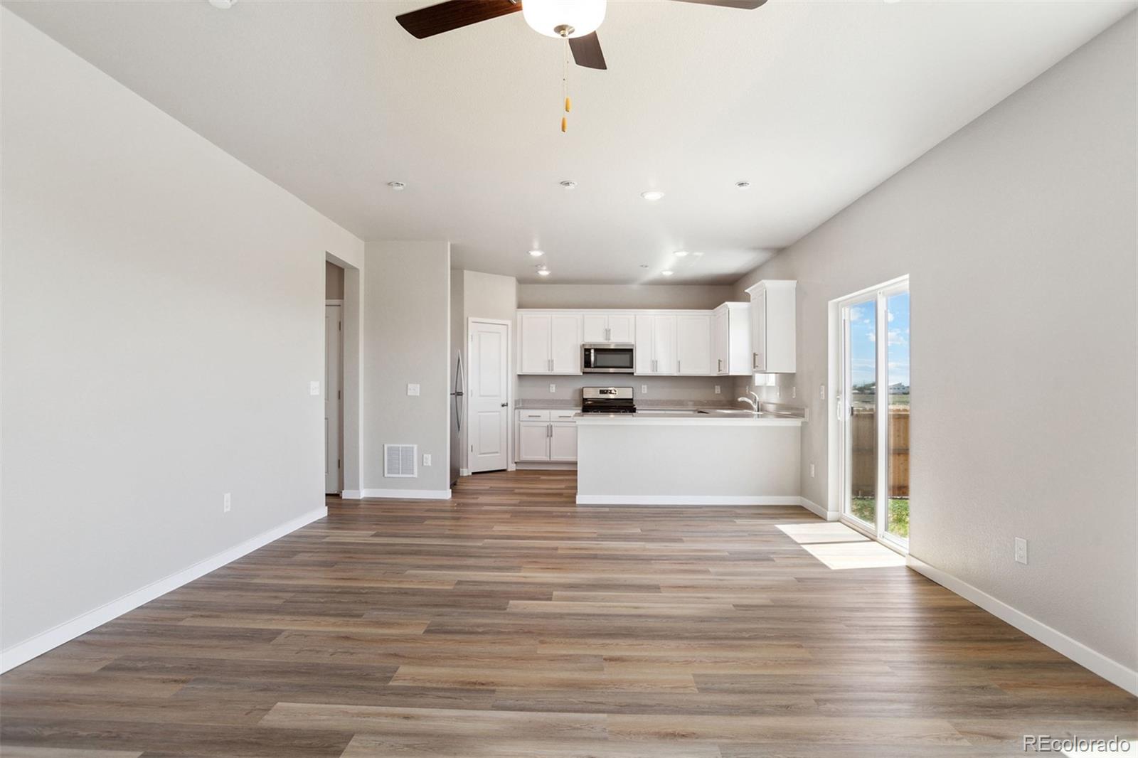 48165 Shetland Drive Bennett, CO 80102 - Photo 4 of 21 a view of kitchen with wooden floor