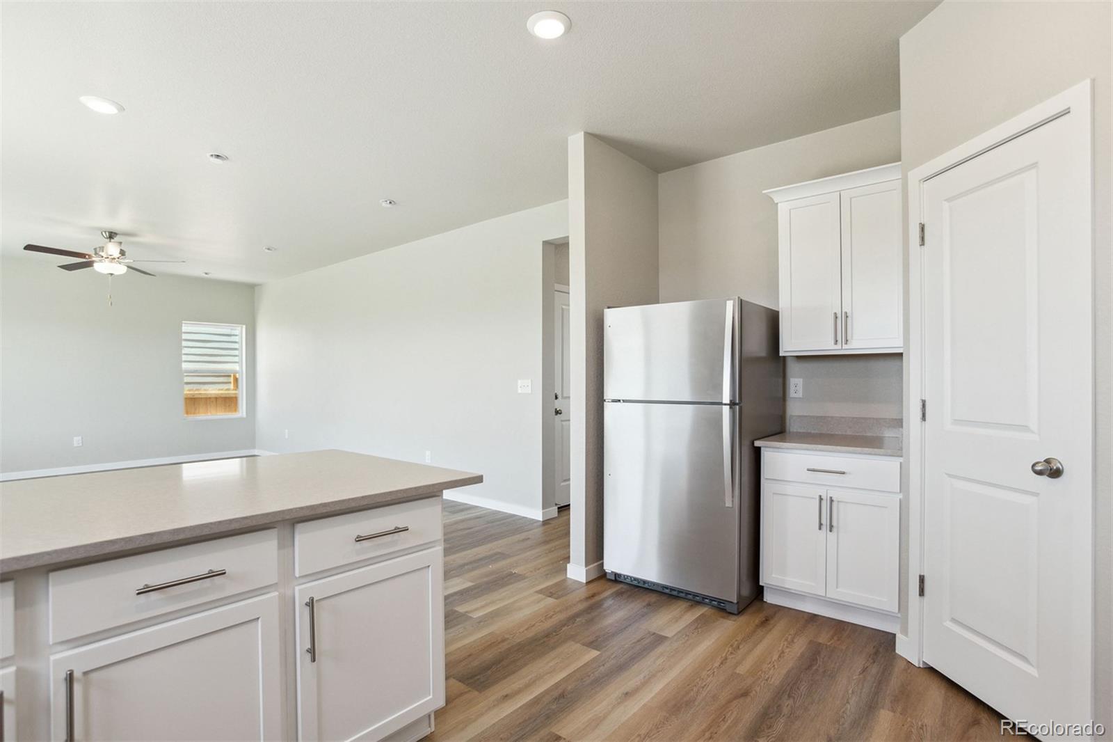 48165 Shetland Drive Bennett, CO 80102 - Photo 10 of 21 a kitchen with a refrigerator and a sink