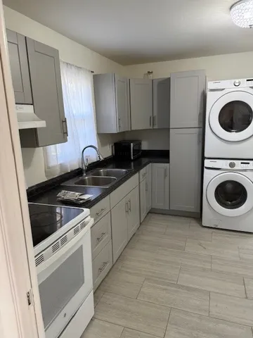a kitchen with a stove top oven and cabinets