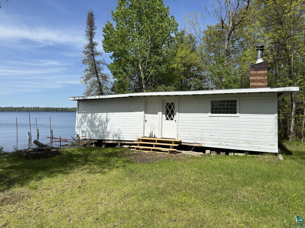 3739 Sundling Road Tower, MN 55790 - Photo 11 of 15 Back of property with a water view and a lawn
