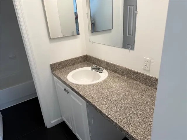 a white toilet and tub sitting next to a bathroom sink