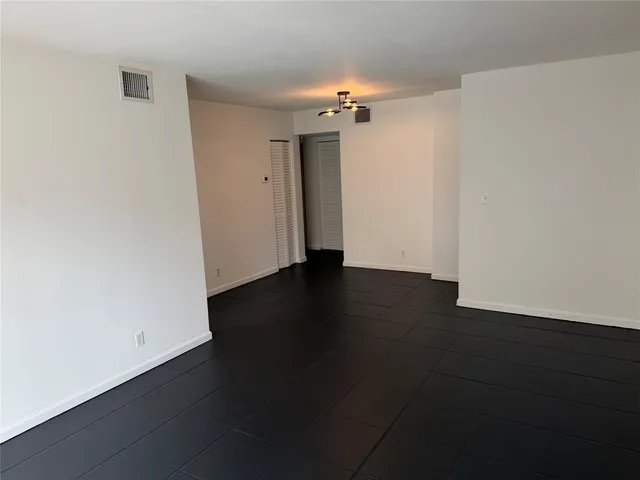 an empty room with wooden floor