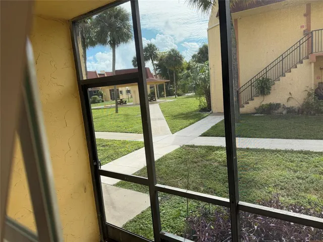 a kitchen with granite countertop white cabinets and stainless steel appliances