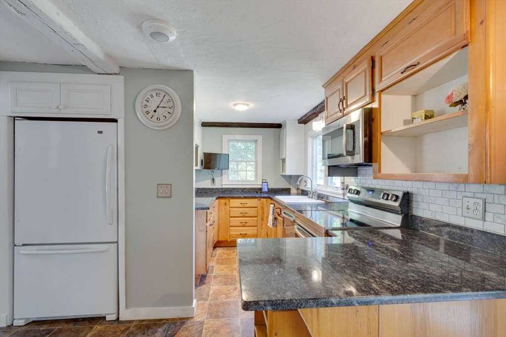 232 Randall Road Berlin, MA 01503 - Photo 13 of 35 a view of a kitchen with stainless steel appliances granite countertop a refrigerator and a sink