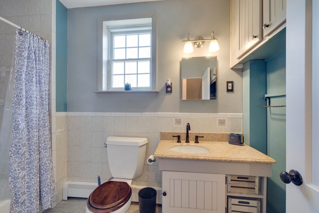 232 Randall Road Berlin, MA 01503 - Photo 23 of 35 a bathroom with a sink a toilet and a mirror