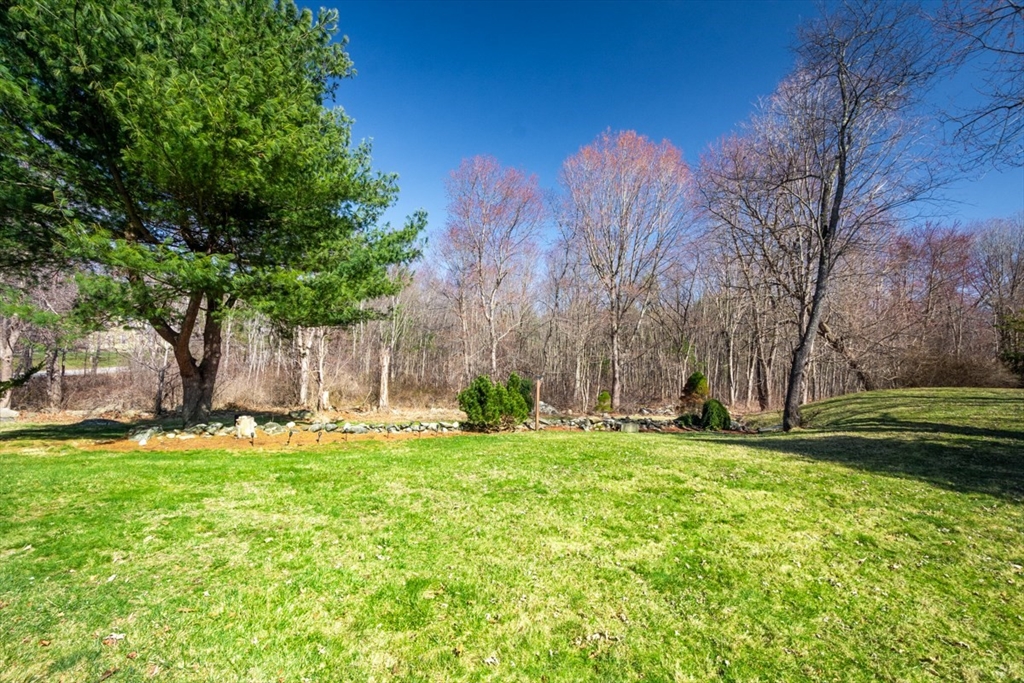 232 Randall Road Berlin, MA 01503 - Photo 30 of 35 a backyard of a house with lots of green space and fountain