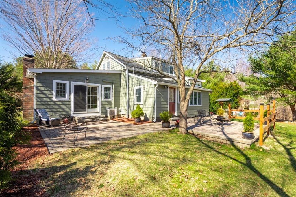 232 Randall Road Berlin, MA 01503 - Photo 31 of 35 a house view with a wooden bench in a backyard
