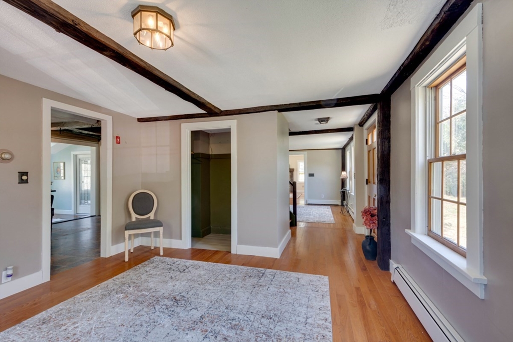 232 Randall Road Berlin, MA 01503 - Photo 8 of 35 a view of a hallway with wooden floor and glass door