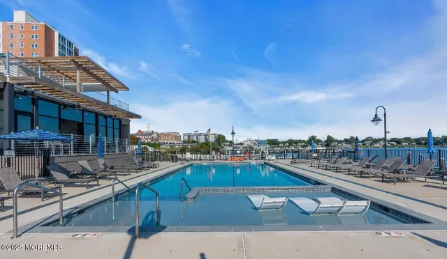 a view of a swimming pool with outdoor seating and a buildings
