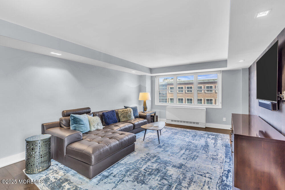 28 Riverside Avenue, Unit 2G Red Bank, NJ 07701 - Photo 11 of 34 a living room with furniture and a flat screen tv