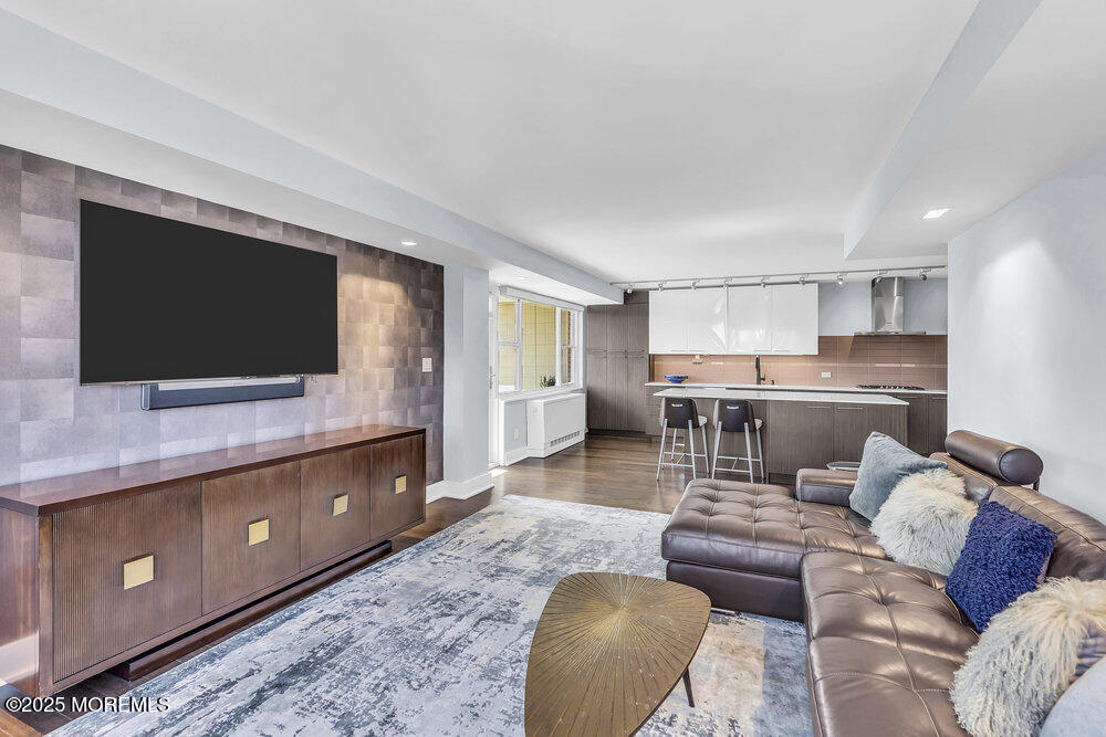 28 Riverside Avenue, Unit 2G Red Bank, NJ 07701 - Photo 14 of 34 a living room with furniture and a flat screen tv