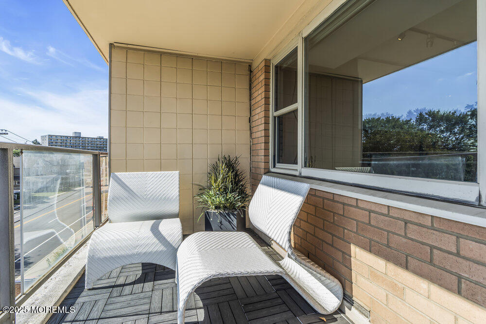 28 Riverside Avenue, Unit 2G Red Bank, NJ 07701 - Photo 20 of 34 a balcony with furniture and a potted plant