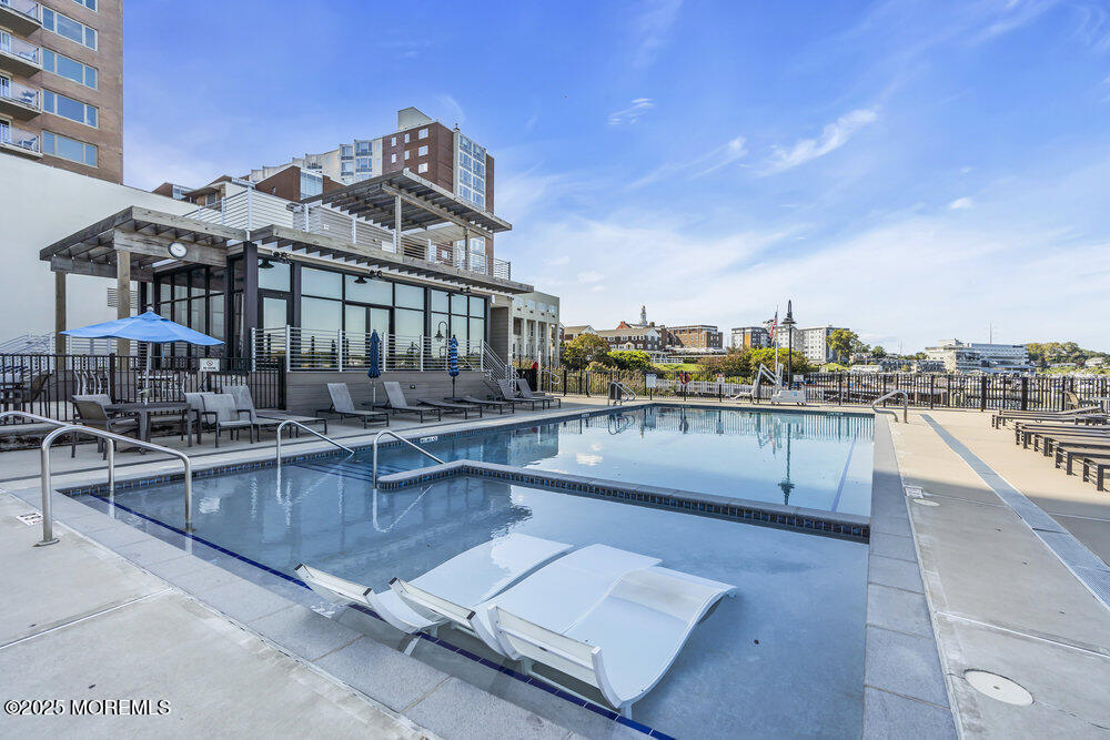 28 Riverside Avenue, Unit 2G Red Bank, NJ 07701 - Photo 31 of 34 a view of a swimming pool with a lounge chair