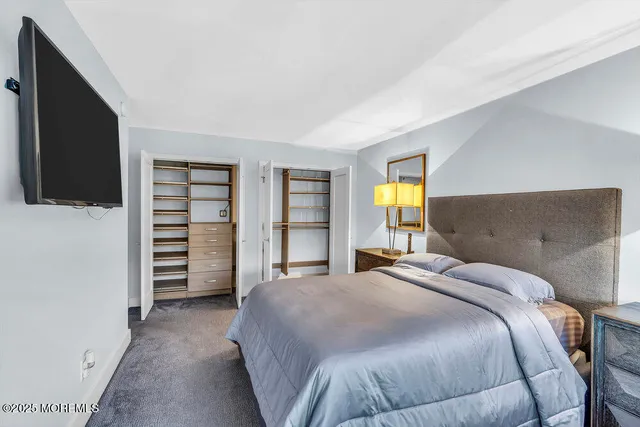 a bedroom with a bed and a television