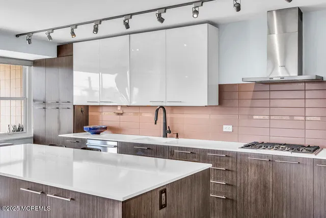 a kitchen with a sink a stove and cabinets