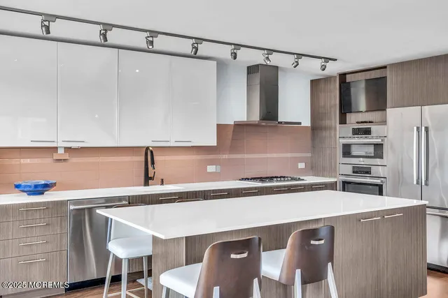 a kitchen with a sink a stove a refrigerator and cabinets