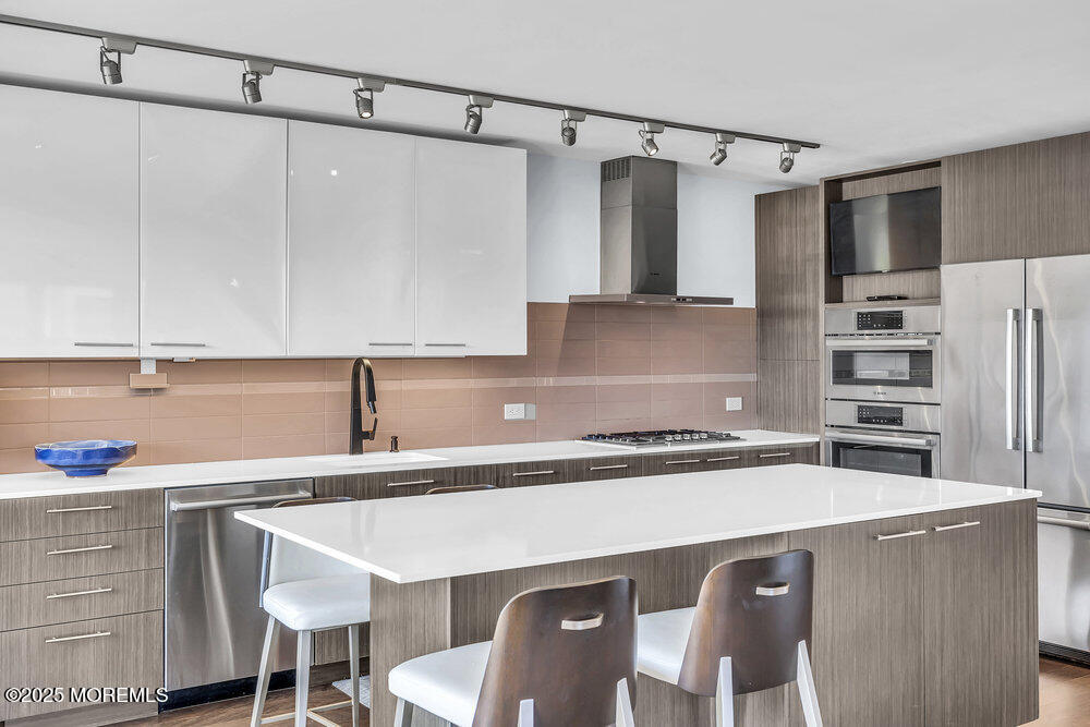 28 Riverside Avenue, Unit 2G Red Bank, NJ 07701 - Photo 10 of 34 a kitchen with a sink a stove a refrigerator and cabinets