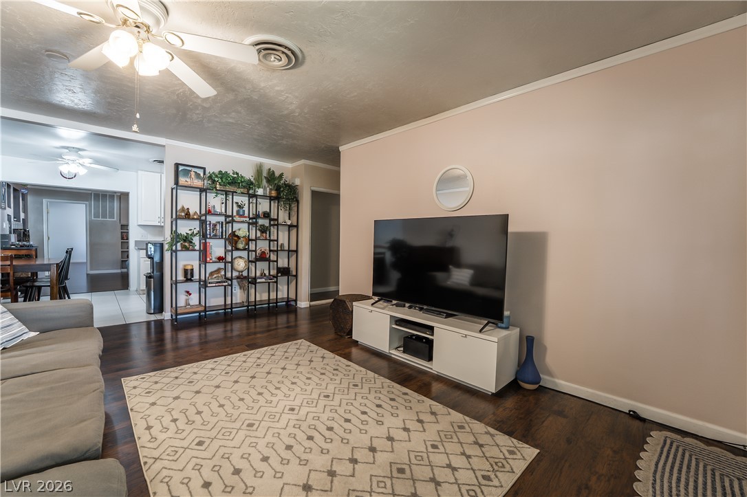 1324 Appaloosa Road Boulder City, NV 89005 - Photo 3 of 42 Rich hardwood floors complement light walls and crown molding in this inviting living space.