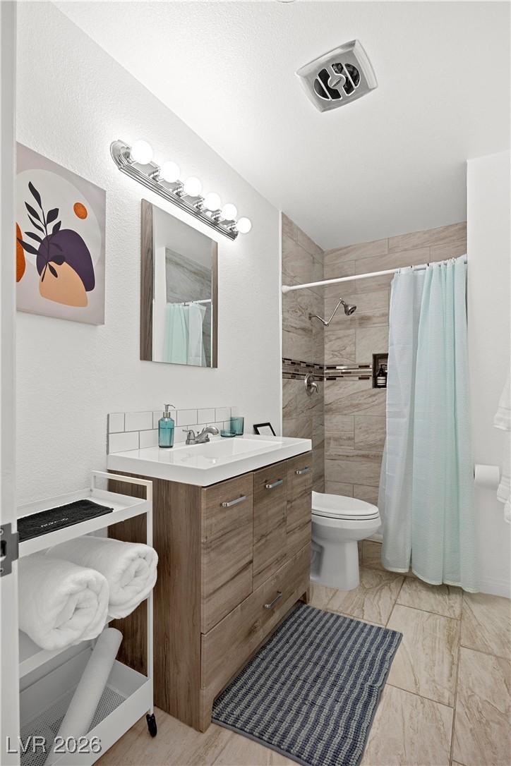 1554 Raindance Way Las Vegas, NV 89169 - Photo 16 of 25 Full bathroom with marble finish floor, visible vents, toilet, a tile shower, and vanity